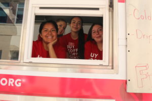Girls Inc. girls serving coffee in their mobile coffee truck