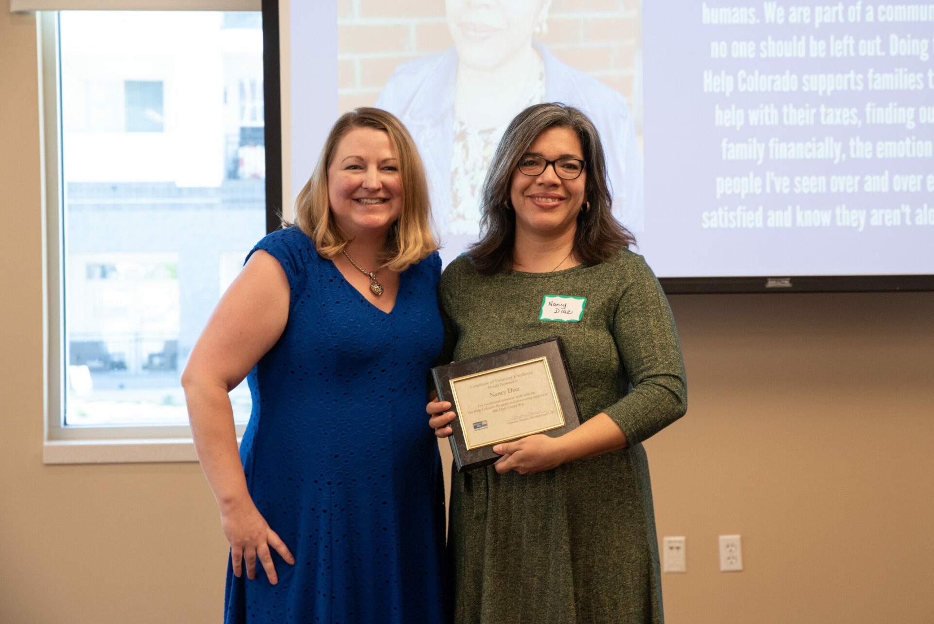 Tax Help Volunteer Nancy Diaz is pictured holding a certificate recognizing her contributions to the free tax assistance program. Joining her is Kristin Hubbard, Program Manager for Tax Help Colorado.